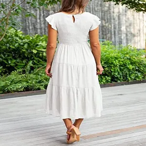 Elegant white tiered midi dress featuring flutter sleeves and a smocked back design