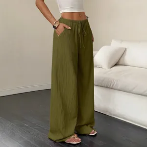 Women's olive green textured wide-leg pants with drawstring waist and side pockets.