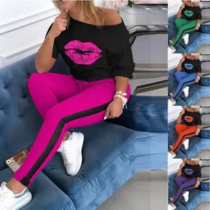 Women's casual two-piece set featuring lip print off-shoulder top and striped joggers