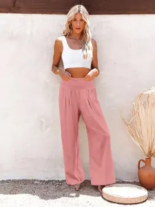 Model wearing pink high-waist wide-leg linen casual trousers in outdoor setting