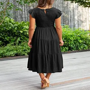 Back view of black tiered midi dress featuring ruffle sleeves and smocked bodice