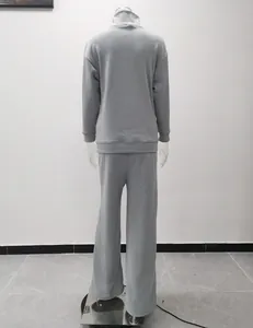 Back view of a grey casual two-piece set with a turtleneck sweatshirt and wide-leg trousers