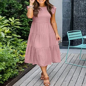 Detailed view of pink tiered midi dress with flutter sleeves and smocked bodice