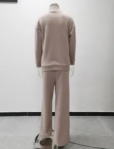 Back view of a casual beige-brown two-piece lounge set with high neck and wide-leg pants