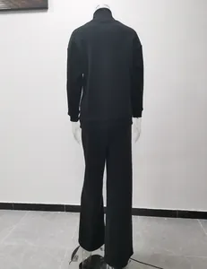 Rear view of a black high-neck sweatshirt and wide-leg trousers loungewear two-piece set