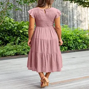 Back view of pink tiered midi dress with flutter sleeves and shirred bodice detail