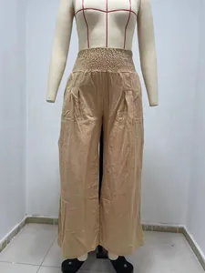 Detail view of women's smocked waist wide leg casual pants in beige