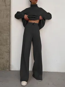 Stylish women's dark grey loungewear set featuring turtleneck top and high-waisted wide-leg pants