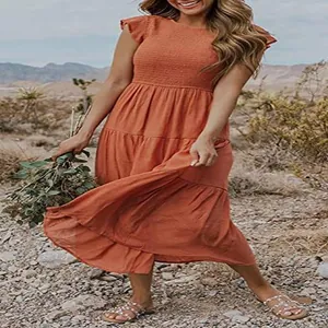 Detailed view of terracotta ruffle sleeve smocked tiered maxi dress in desert landscape