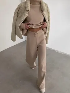 Elegant women's beige knit lounge set featuring high-neck top and matching wide-leg trousers