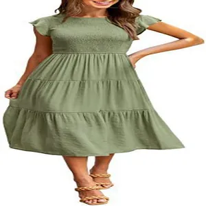 Detailed view of sage green tiered midi dress with smocked bodice and fly sleeves
