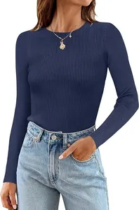 Detail view of a navy blue ribbed long-sleeve top paired with blue denim jeans.