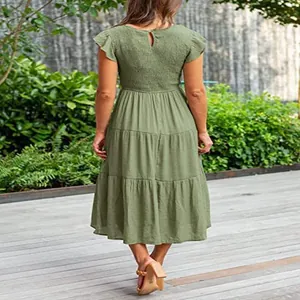 Back view of olive green tiered midi dress with flutter sleeves and smocked bodice.