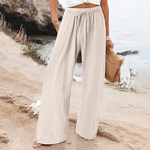Detailopname van beige katoenen linnen broek met wijde pijpen voor dames strand