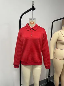Detailed view of red quilted sweatshirt for women with classic polo collar and buttons