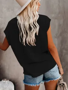 Back view of a casual black crew neck t-shirt paired with denim shorts and a stylish hat.
