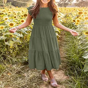 Detail of army green midi dress with flutter sleeves and tiered skirt in sunflower field