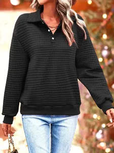 Close-up of a black quilted polo sweatshirt featuring a stylish buttoned collar design