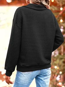 Back view of a black women's sweatshirt with a quilted grid texture and high collar.