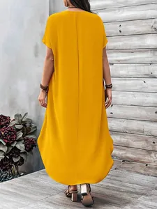 Back view of a loose yellow maxi dress with short sleeves and curved hem for women