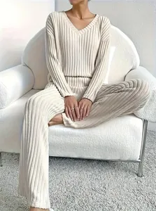 Close-up of a women's beige ribbed two-piece lounge set with V-neck top and pants