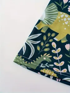Detailansicht des Rocksaums mit niedlichem Dinosaurier- und Blumenmuster-Print