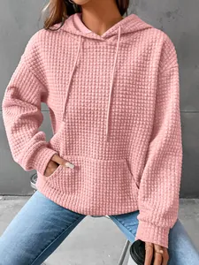 Women's pink waffle knit long sleeve hoodie with front pocket and drawstring