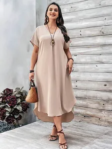 Close-up of plus size V-neck dress with high-low hem in apricot