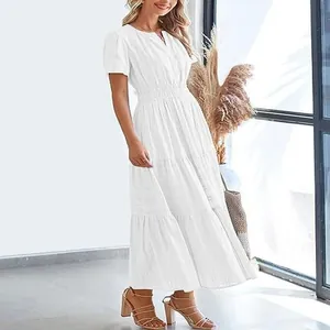Close-up detail of a white V-neck tiered maxi dress with elegant puff sleeves