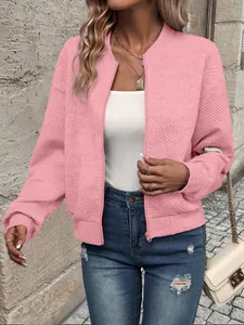 Close-up view of a pink textured bomber jacket featuring a zipper and ribbed collar detail