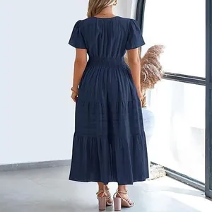 Elegant navy blue tiered maxi dress with short puff sleeves and layered skirt design