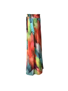 Detail view of colorful feather print wide-leg bohemian trousers with pleated high waist.