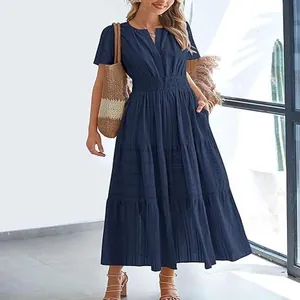 Elegant navy blue V-neck tiered maxi dress with pleated fabric and short puff sleeves