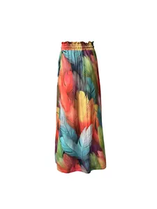 Detail showing colorful 3D feather print and pleated elastic waist of bohemian skirt