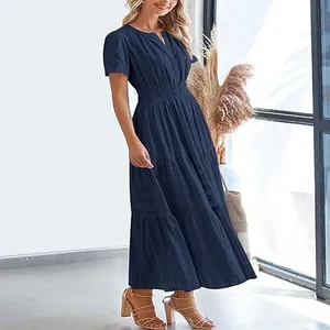 Full-length view of a navy blue V-neck tiered maxi dress with puffed sleeves on a model.