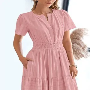 Detailed macro view of pink V-neck dress featuring bubble sleeves and pleated waist texture