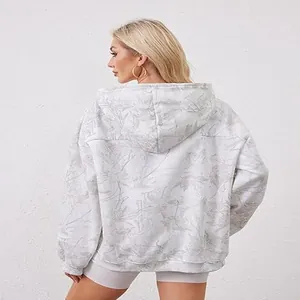 Detailed back view of a white oversized hoodie with subtle grey floral leaf print