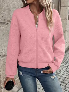 Detailed view of women's pink zip-up jacket featuring an elegant textured pattern design