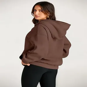 Detail view of the back of a comfortable brown oversized hooded sweatshirt for women.
