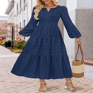 Close-up detail of women's navy blue V-neck tiered maxi dress with elegant puff sleeves