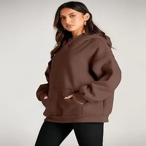 Oversized brown hooded sweatshirt for women, featuring a front pocket and relaxed fit