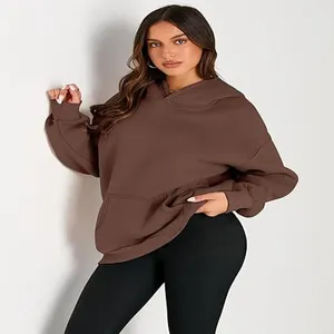 Close-up detail of women's brown oversized hoodie with a hood and front kangaroo pocket