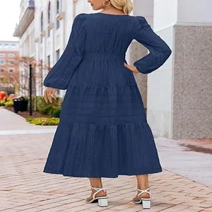 Back view of a navy blue tiered bubble sleeve dress featuring elegant textured fabric