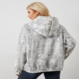 Back view of a stylish women's grey and white forest leaf print oversized hoodie