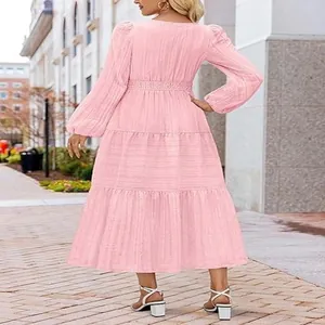 Detailed back view of a pink tiered maxi dress with puff sleeves and elastic waistline.