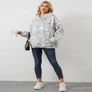 Full-body view of women's oversized marble print hoodie with functional front pocket