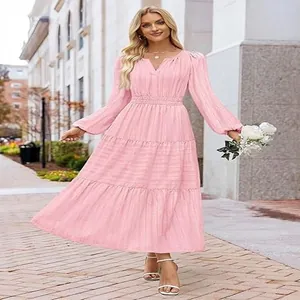 Elegant pink V-neck tiered maxi dress with puff sleeves shown in a street setting