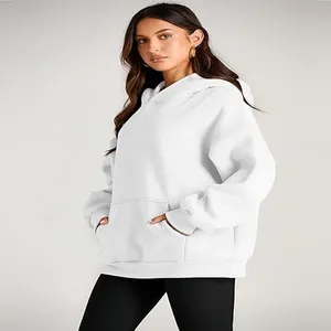 Detailed side view of a white oversized women's hooded sweatshirt worn by a model