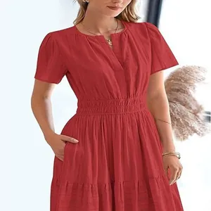 Detail view of a vibrant red V-neck tiered dress with puff sleeves and waist smocking