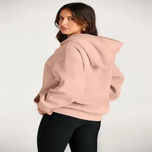 Back view of women's loose dusty pink hooded sweatshirt with soft fabric texture